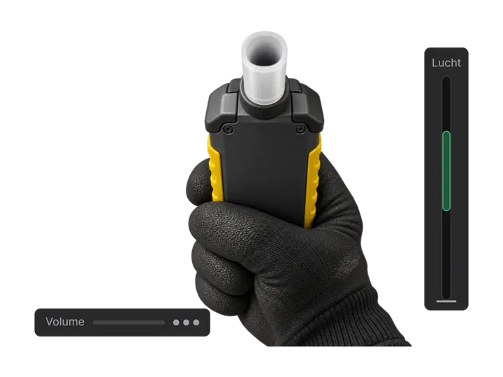 Gloved hand holding a yellow breathalyser with an airflow meter beside it