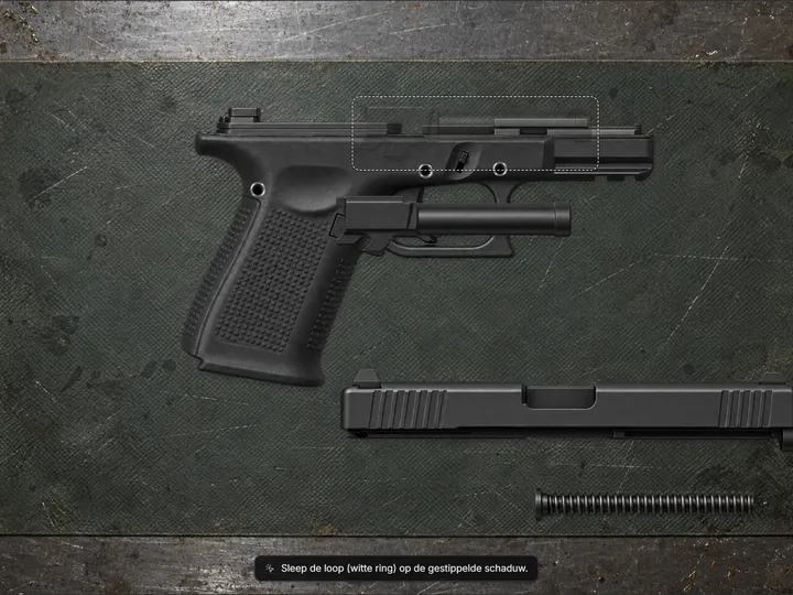 Pistol barrel being placed into an open frame on a workbench mat, slide and spring waiting below