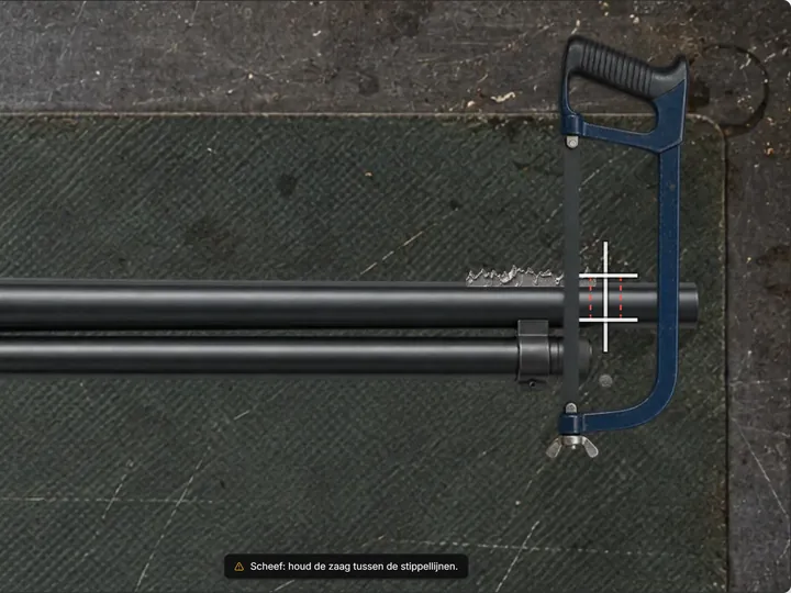 Hacksaw cutting a double shotgun barrel on the marked line