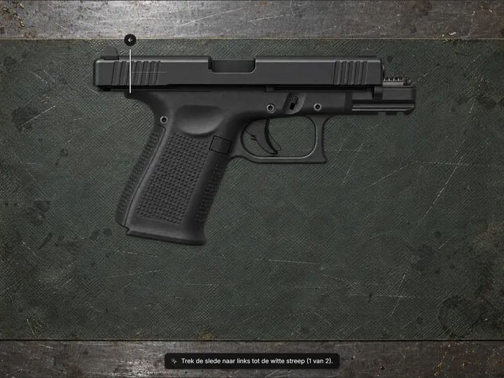 Assembled pistol on a workbench mat with the slide being pulled back