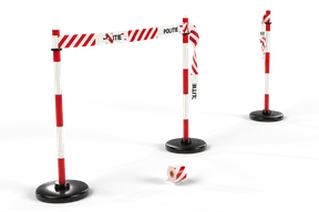 Red and white POLITIE tape tied between two red and white posts on round black rubber feet; the next piece is torn and hangs from both posts, and a roll of tape lies in front