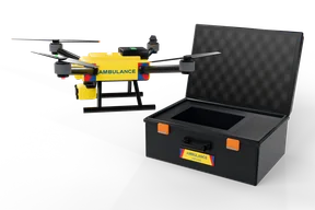 Yellow ambulance drone with blue AMBULANCE lettering hovering beside its open case