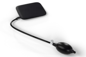 The black rubber air wedge with a fine diamond texture, its hose running from the outlet at one corner to a black hand pump with a chrome release valve
