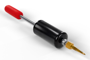 Slide hammer lying on the floor: red rubber grip, steel rod, knurled black slide weight and a brass screw tip