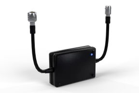 Small black video loop box with a blue status light and two BNC pigtails, one male and one female plug