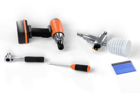 An orange and black cordless impact wrench and a chrome spray gun with a white cup lying on their sides, with a ratchet, an orange-handled screwdriver and a blue felt squeegee in front